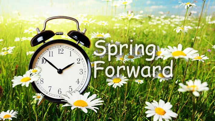 Clock in a field of flowers with text that reads Spring Forward!